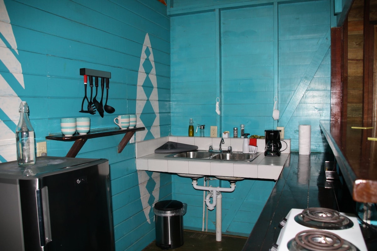 Turquoise kitchen area inside Bungalow Left at SurfBreak at Paunch