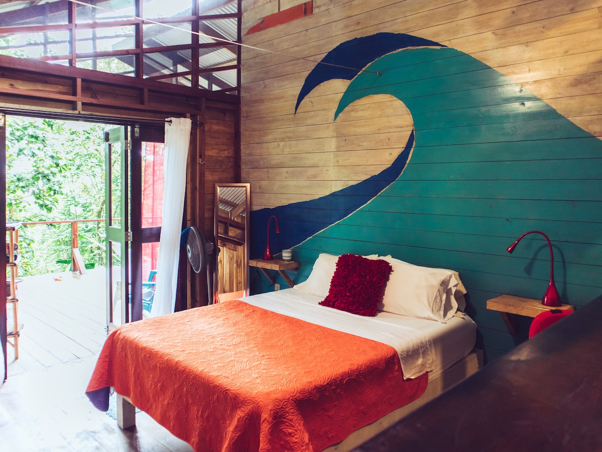Blue wave mural inside Bungalow Left at SurfBreak at Paunch